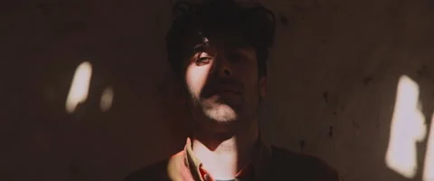 Man standing by the wall looking into camera Stock Footage 202267048