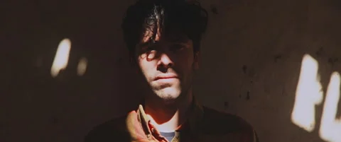 Man standing by the wall looking towards camera close up Stock Footage 202267233