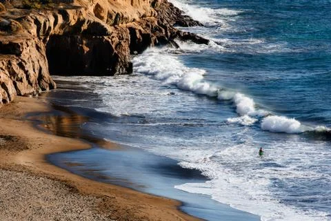 Man standing in the waves. Taurito beach, Gran Canaria. Stock Photos