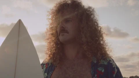 Man standing while holding his surfboard Stock Footage 275163905