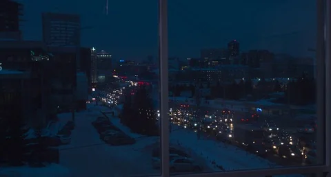 The man Standing At the Window On the Background of night city .4k Stock Footage 73443560