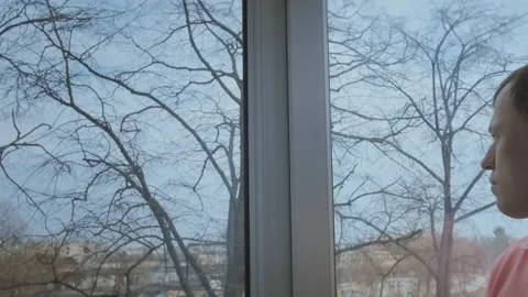 A man standing by the window watching what's going on outside, copy space Stock Footage 161195348