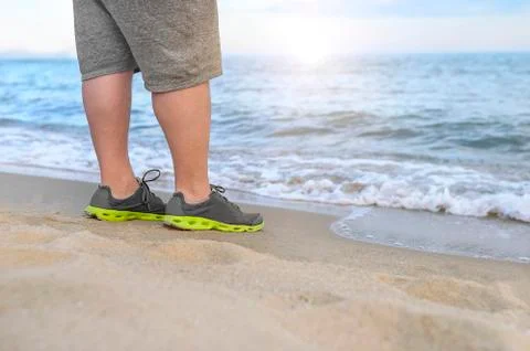 Man stands on the beach. Stock Photos