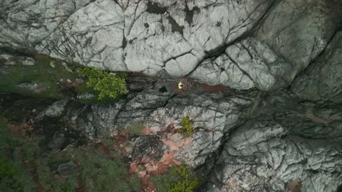 Man stands between rocks and takes off on drone, Stock Footage 226932972