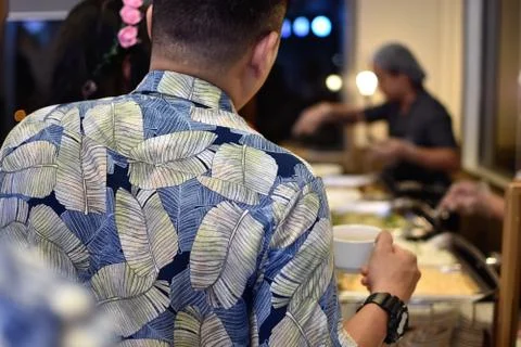 A man stands in a buffet line Stock Photos