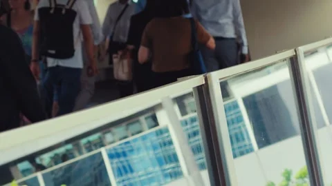 A man stands in a bustling indoor space, likely a public area such as a shopping Video stock 338311439