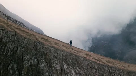 A man stands on the caldera of the active volcano Bromo. Java Island Stock Footage 253648140