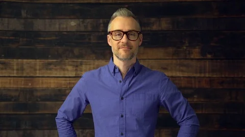Man stands confidently with hands on hips Stock Footage 85425284