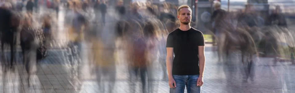 The man stands on the crowded street Stock Photos