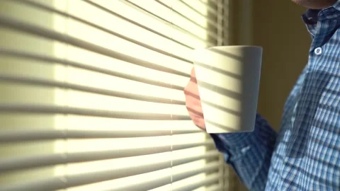 A Man Stands with a Cup in the Office in front of the Window. Stock Footage 150455268