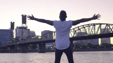 Man Stands At The Edge Of A Dock And Spreads His Arms Wide, Full Of Joy Stock Footage 67970474