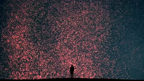 The man stands on the falling shimmering particles background Stock Footage 165356266