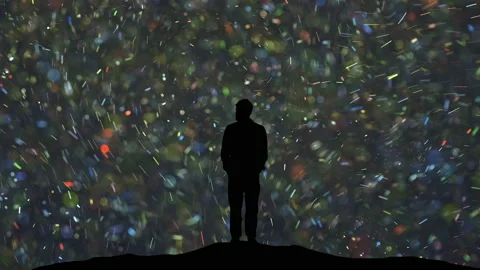 The man stands on a flying shimmering particles background Stock Footage 165355016