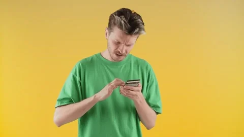 A man stands in front of the camera and quickly scrolls across the smartphone Stock Footage 240289994