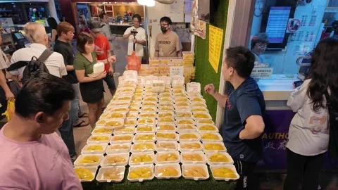 A man stands in front of a table full of durian fruit Vídeo Stock 318104356