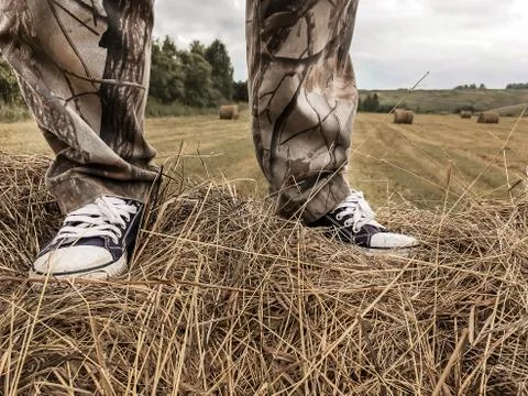 A man stands on a haystack Stock Photos