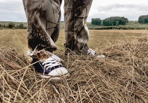 A man stands on a haystack Stock Photos