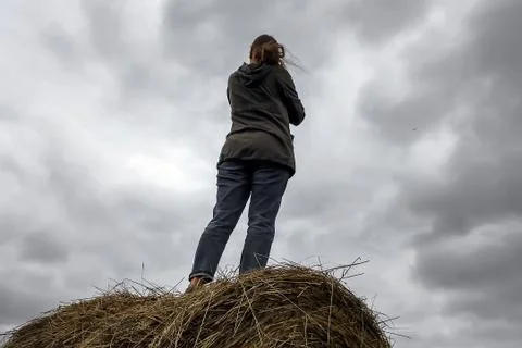 A man stands on a haystack Stock Photos