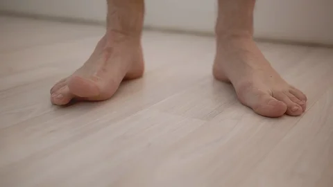 Man stands on the light floor with bare feet Stock Footage 130066868