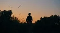 The man stands on the mountain on a sunset background 4k or 4k+ Resolution