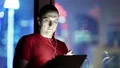 Man stands near window in hotel room and uses tablet pc HD Footage