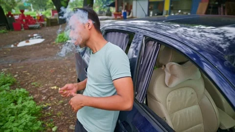 Man stands by parked car lighting cigarette with lighter Stock Footage 297601729