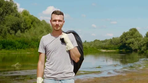 Man is stands with a plastic bag and shows thumbs up. Stock Footage 122613435