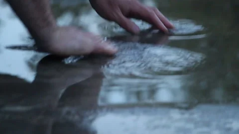 Man stands in a puddle after the rain with bare feet Stock Footage 107993184