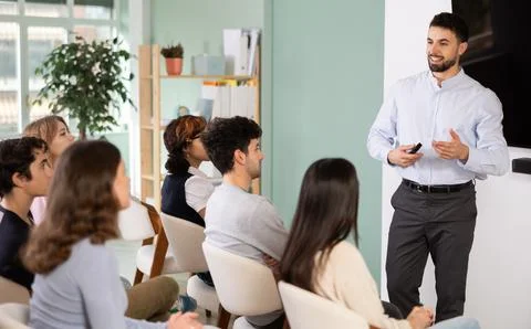 Man stands with a remote control in front of students Stock Photos