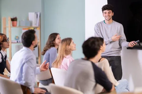 Man stands with a remote control in front of students Stock Photos