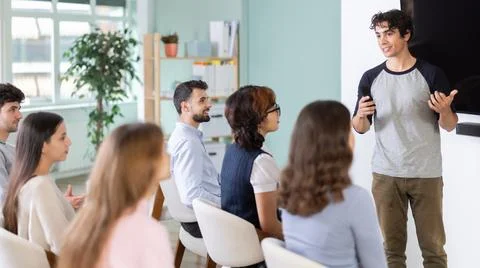 Man stands with a remote control in front of students Stock Photos