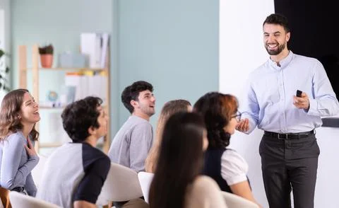 Man stands with a remote control in front of students Stock Photos