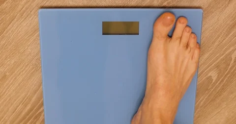 A man stands on the scales Stock Footage 86693570