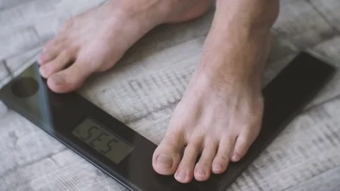 The man stands on the scales. Stock Footage 97333003
