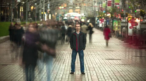 The man stands in the smashed silhouette crowd, time lapse Video stock 32660647