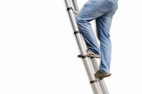 A man stands on a step ladder in a side view on an empty white wall. Stock Photos