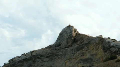 A man stands on the top of a cliff. Video stock 96933031