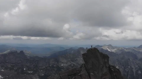 A man stands on top of a mountain. Video stock 92042529