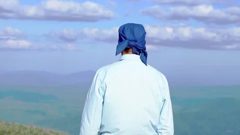 A man stands on top of a mountain 스톡 동영상 135952314