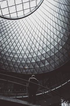 Man stands under patterned dome window Stock Photos