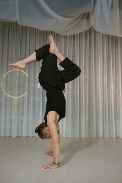A man stands upside down on his hands in the gym Fotos de archivo