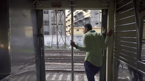 A man stands in the vestibule of the train 스톡 동영상 90965606