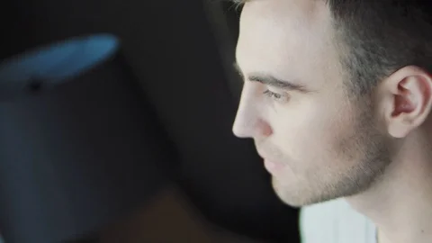 A man stands at a window and drinks water Stock Footage 124114480