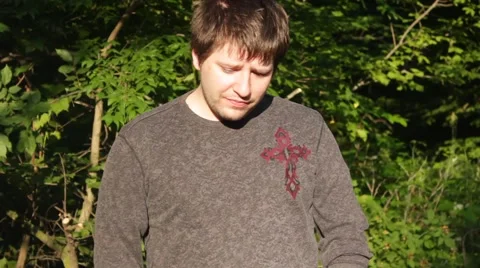 Man stares at ground, talking a little Stock Footage 40212671
