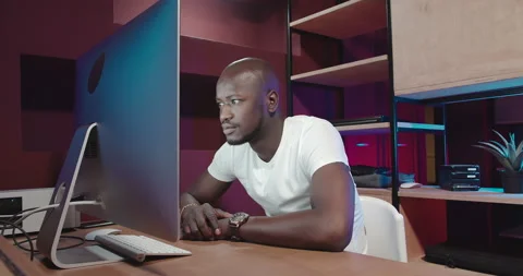 The man stares at the screen and is suddenly surprised Stock Footage 155003563