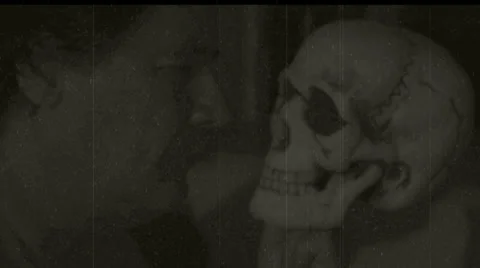 Man stares at skull 2 Stock Footage 32030111