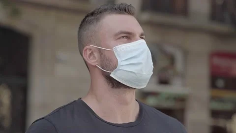 Man staring at the city with a protective face mask on Video stock 140107141