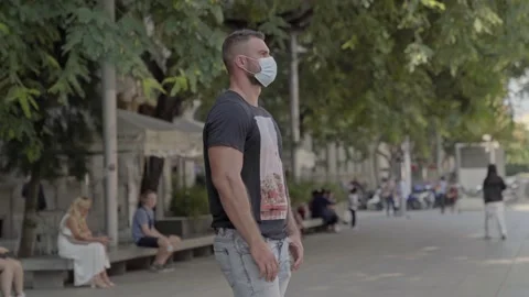 Man staring at the city with a protective face mask on Video stock 140107286