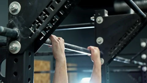 Man start doing hanging pull ups in gym. Fitness man training indoors Stock Footage 272322163