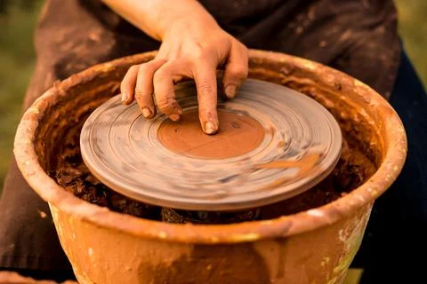 Man start to make ceramic pottery on wheel, creation of ceramic ware. Stock Photos